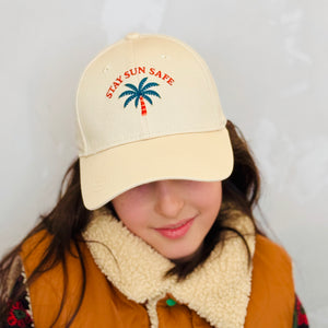 Kids wearing beige cotton baseball cap with Stay Sun Safe embroidery