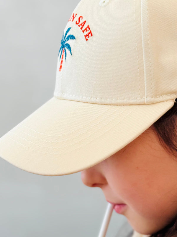 Side view of kids beige cotton baseball cap made from 100 percent cotton